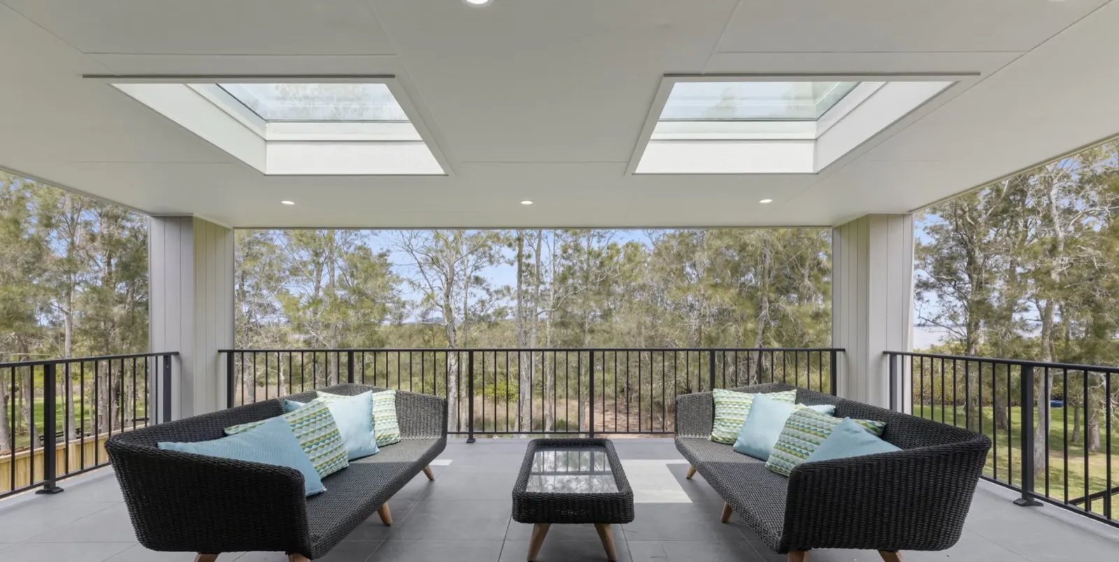 Undercover alfresco deck with lounge seating overlooking the bush and Myall River at Drift, Tea Gardens