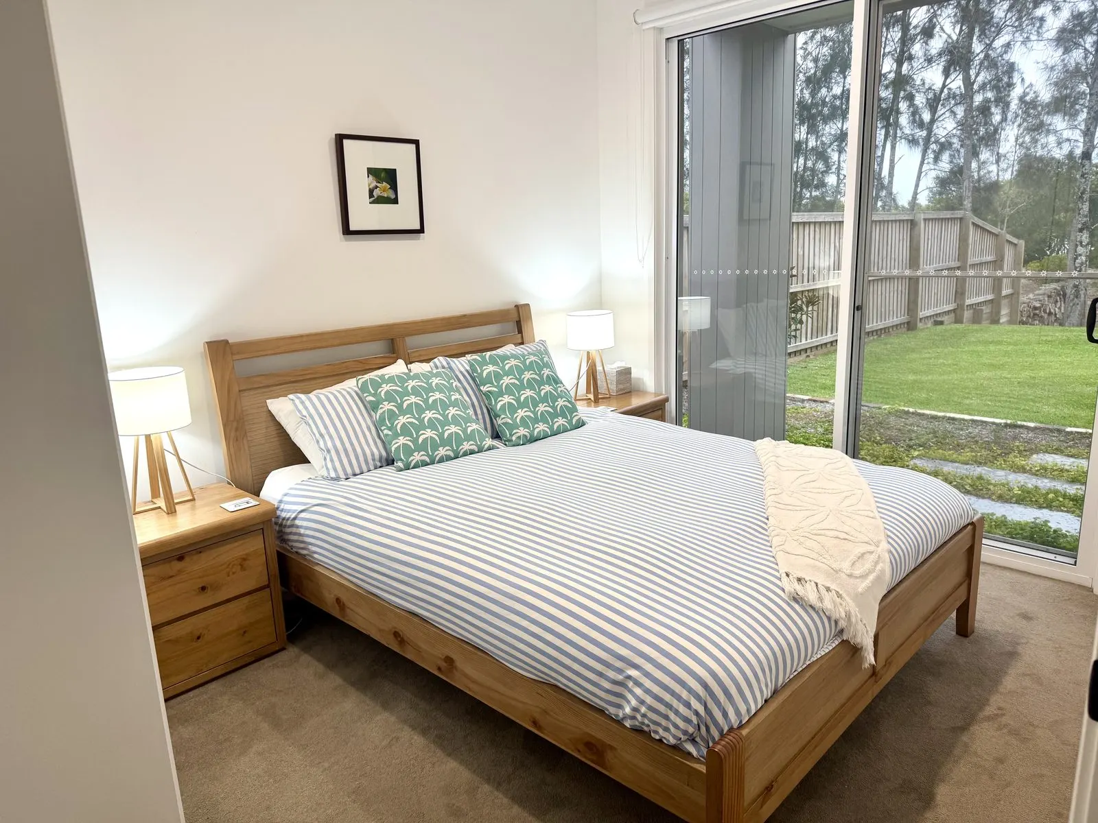 Riverside bedroom with striped linen and afternoon light at Drift