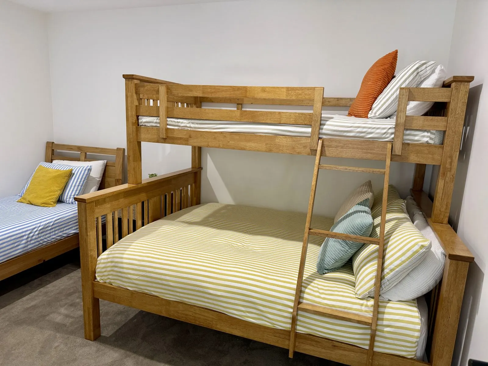 Bunk room with triple bunk and single bed at Drift, Tea Gardens