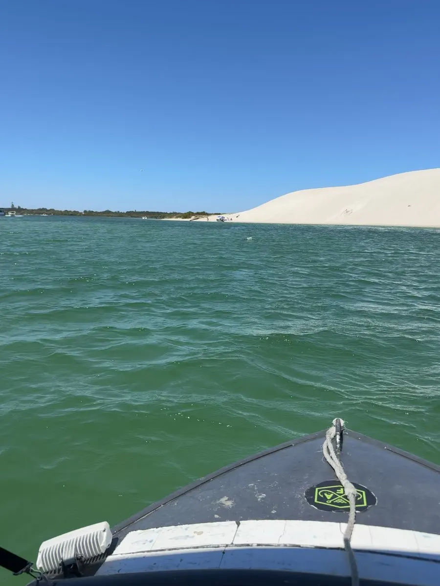 Heading out by boat past the sand dunes near Hawks Nest